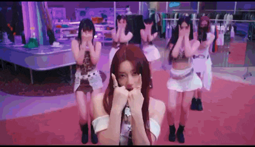 a group of women are dancing on a red carpet .