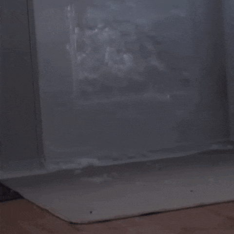 a painting of a cloudy sky is sitting on a table in a room .
