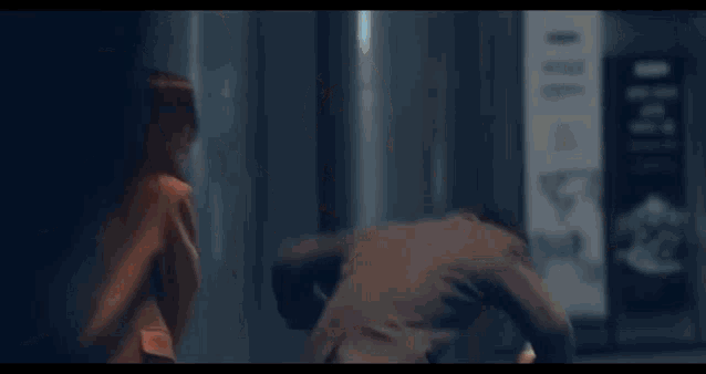 a man and a woman are standing next to each other in a room .