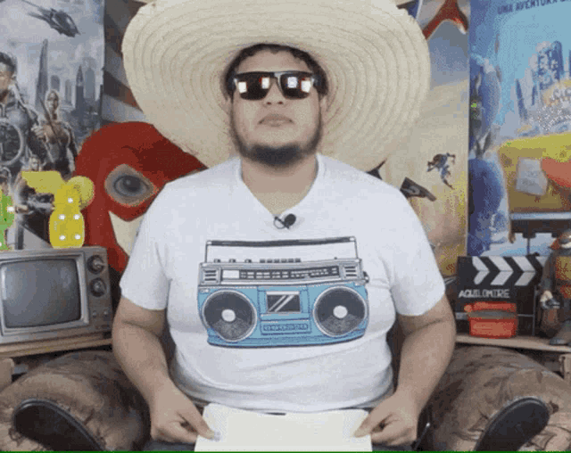 a man wearing a sombrero and sunglasses is holding a piece of paper