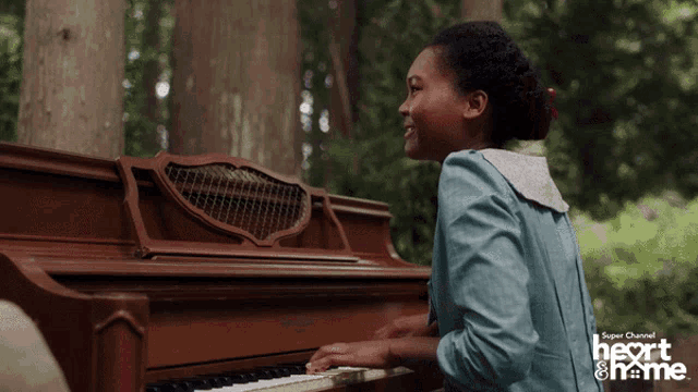 a girl is playing a piano in a super channel heart & frame advertisement