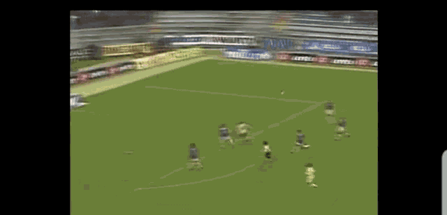 a soccer game is being played in a stadium with ads for lotto