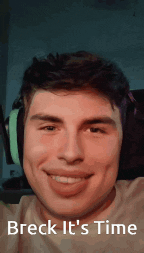 a young man wearing headphones is smiling with the words breck it 's time below him