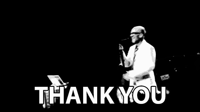 a black and white photo of a man singing into a microphone with the words thank you in white letters behind him