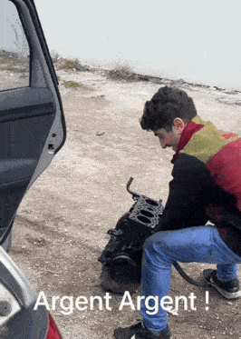 a man is working on a car engine with the words argent argent written on the bottom