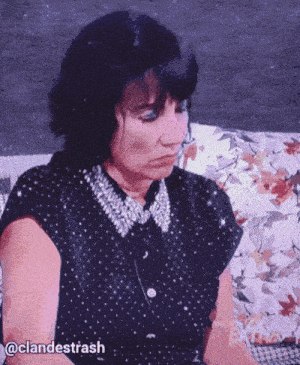 a woman sitting on a couch with a watermark that says clandestrash on it