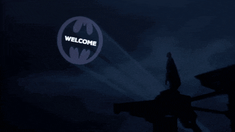 a batman logo that says welcome is projected in the sky