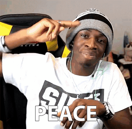 a man wearing a hat and headphones says peace