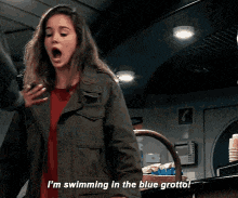 a woman in a green jacket says i 'm swimming in the blue grotto ..