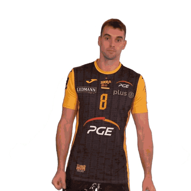 a man wearing a black and yellow pge shirt