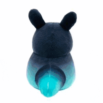 a black stuffed animal with red eyes is sitting on a blue cushion .
