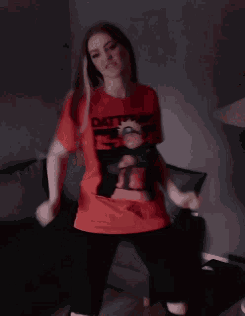 a woman wearing a red shirt that says dattebayo