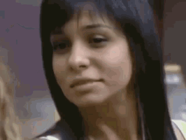 a close up of a woman 's face making a funny face .