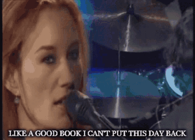 a woman singing into a microphone with the words " like a good book i can 't put this day back " below her