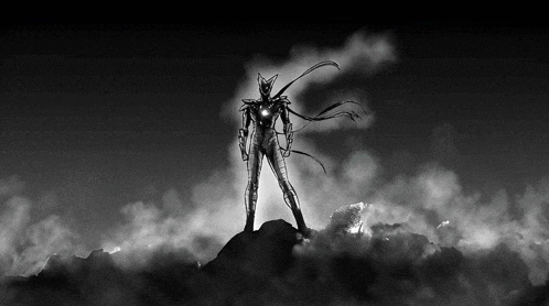 a black and white drawing of a superhero standing on top of a rock .