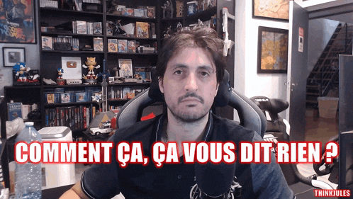 a man sitting in a chair with the words comment ca ca vous dit rien written in red