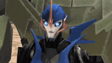 a close up of a robot with blue eyes standing next to another robot