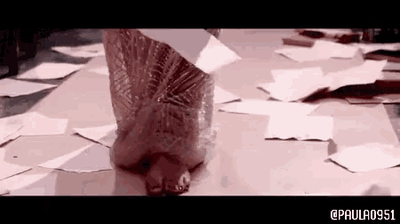 a woman in a dress is standing on a pile of papers with the hashtag paula0951 at the bottom