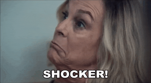 a close up of a woman 's face with the words `` shocker '' written on it .