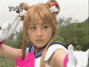 a woman in a sailor moon costume is giving a peace sign