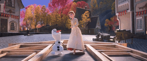 a woman in a white dress stands next to an olaf
