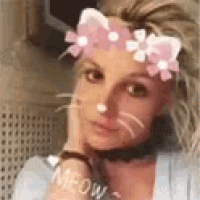 a woman wearing a hello kitty face mask and a choker .