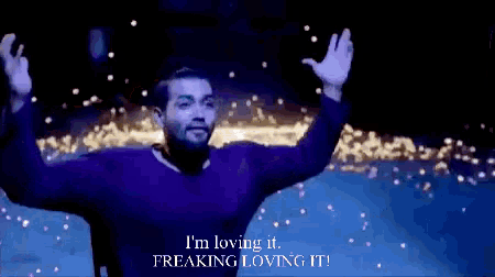 a man with his arms outstretched says i 'm loving it