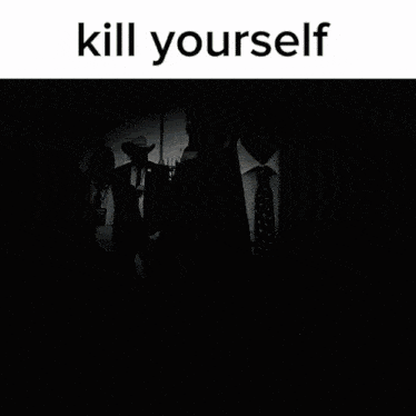 a man in a suit and tie is walking down a street with the words kill yourself behind him