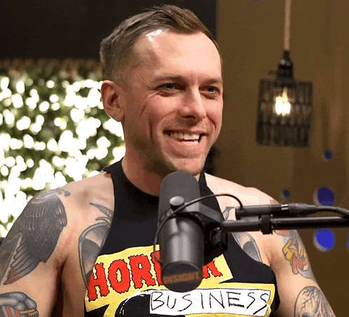 a man wearing a shirt that says " business " on it