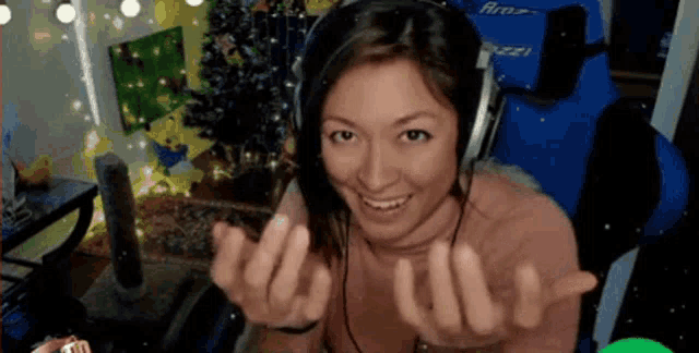 a woman wearing headphones is sitting in front of a blue chair with the word buzz on it