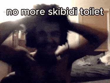 a man wearing headphones with the words no more skibidi toilet written above him