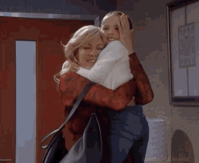 a woman is hugging a little girl with the words queen of almeras on the bottom