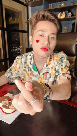 a man with red lips and a heart on his forehead