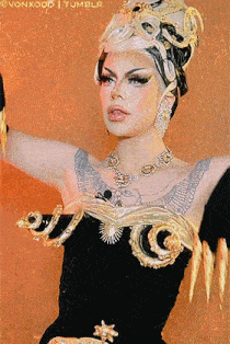 a woman with a tattoo on her arm is wearing a black and gold outfit