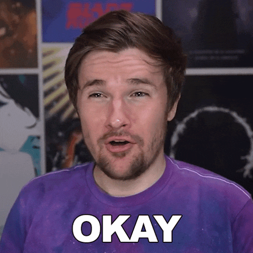 a man in a purple shirt says okay in white letters