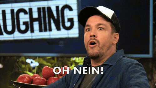 a man in a baseball cap says " oh nein " in front of a sign that says laughing