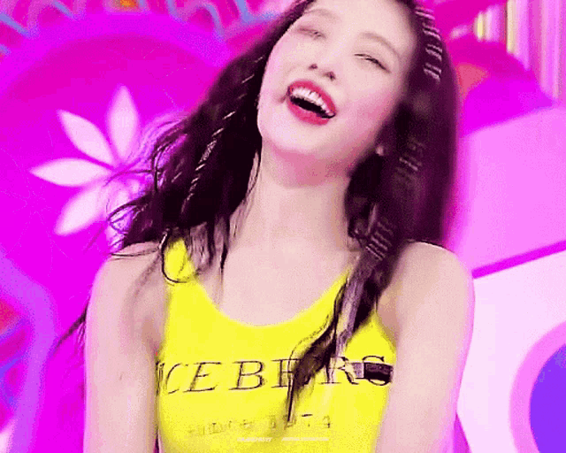 a woman wearing a yellow tank top that says iceberg