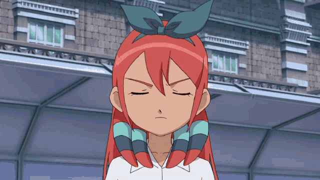 a girl with red hair and a bow in her hair looks angry