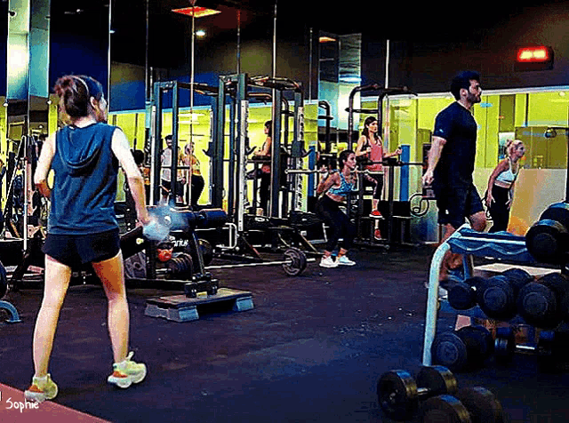 a group of people in a gym with the name sophie on the bottom left