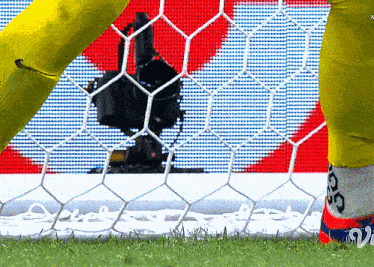 a soccer goalie wearing a pair of socks that say ' gs ' on them
