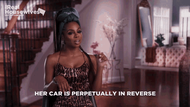 a woman in a leopard print dress is talking about her car