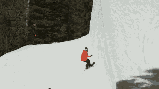 a snowboarder wearing a black hoodie with the letter t on it