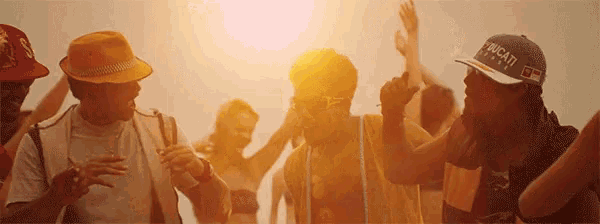 a man wearing a ducati hat is dancing with others