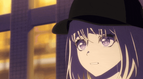 a close up of a girl wearing a black hat