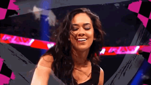 a woman is smiling in front of a sign that says raw .