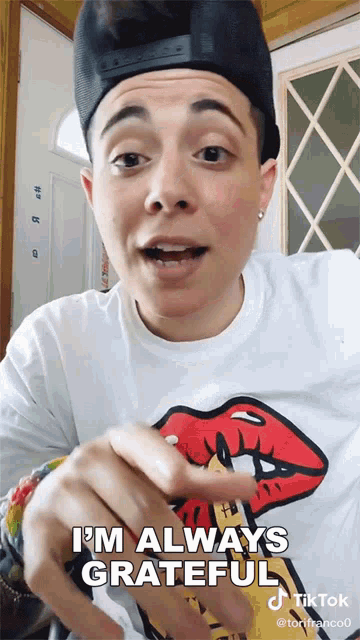 a woman wearing a hat and a t-shirt says i 'm always grateful