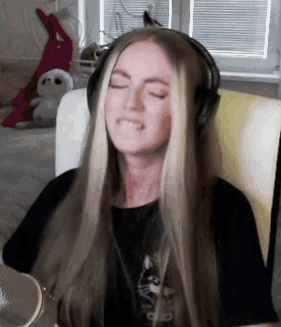 a woman wearing headphones is sitting in a chair