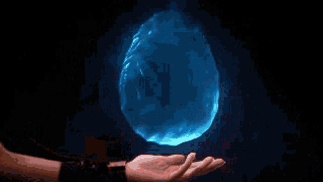 a person is holding a glowing ball in their hand