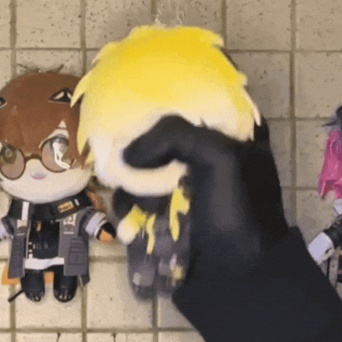 a person is holding a stuffed animal that has a tag that says ' t.i.f. ' on it