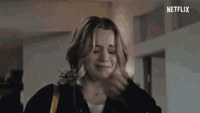 a woman is crying and covering her mouth with her hand in a netflix ad